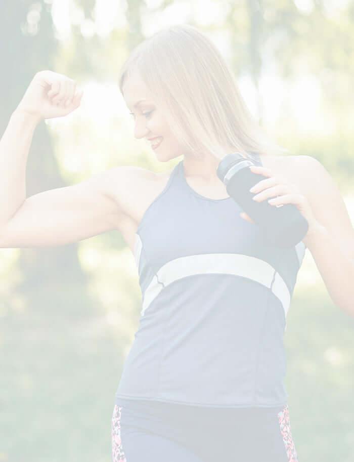 lady flexing arm muscles after a run in the park