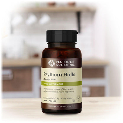 A bottle of Nature's Sunshine Psyllium Hulls capsules on a kitchen counter