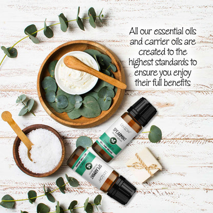 Spearmint Essential oil with eucalyptus leaves on a wooden surface