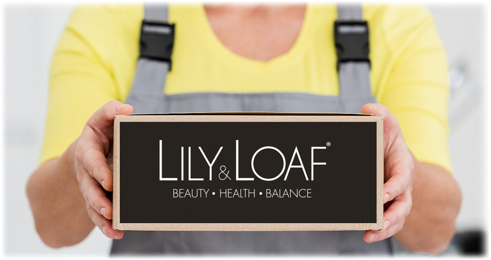 Person in yellow shirt holding a box with the Lily & Loaf logo, representing the delivery of beauty, health, and balance products.