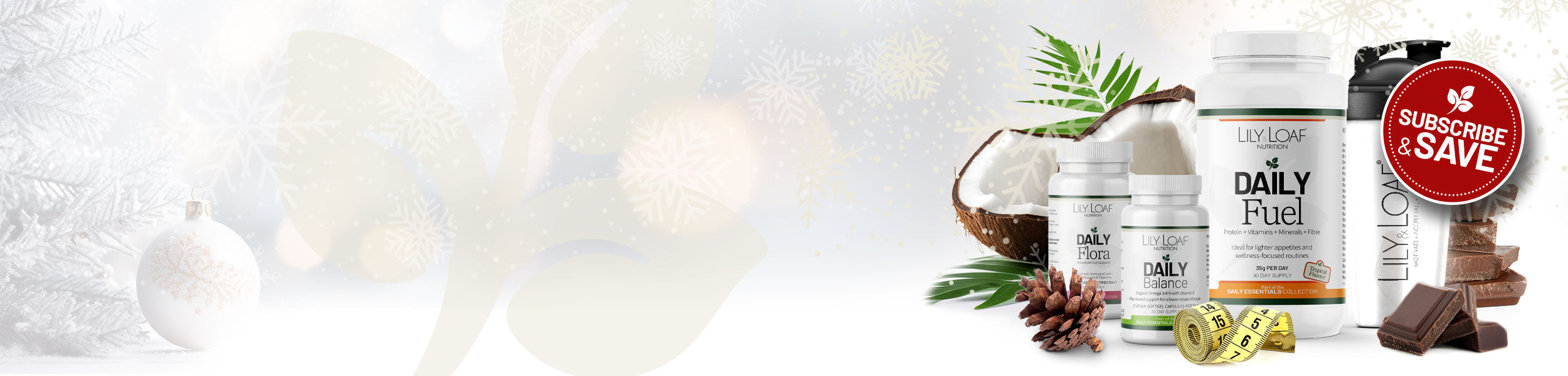 Festive banner with Lily & Loaf Daily Essentials products, coconut, chocolate pieces and a red Subscribe & Save badge on a snowy Christmas background.