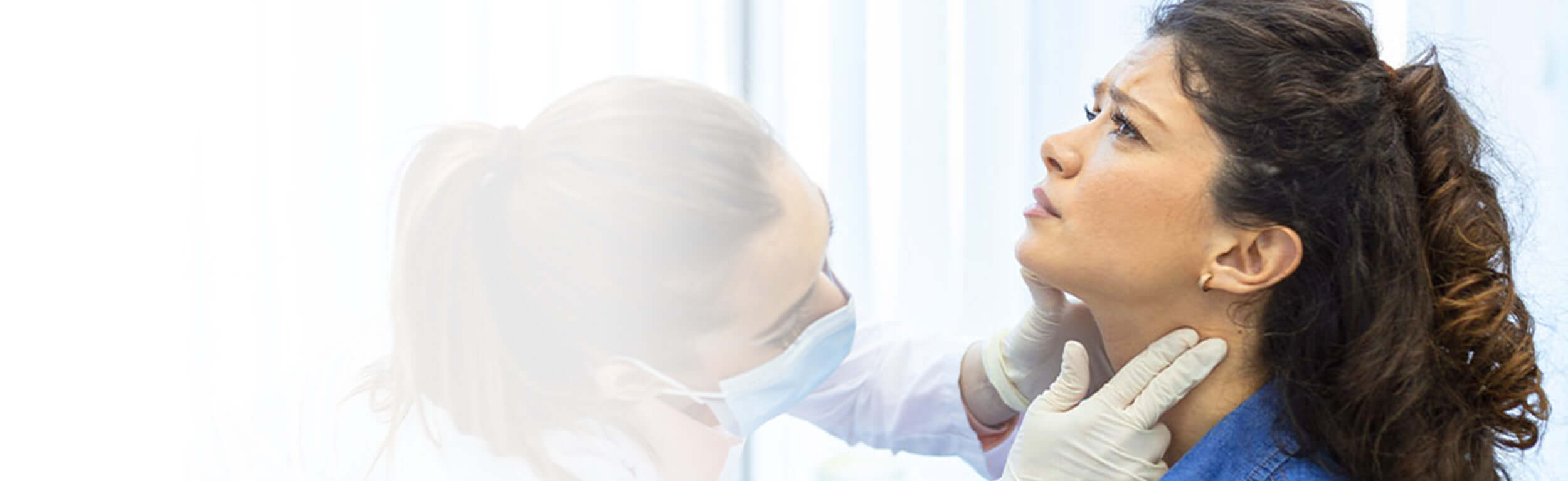 A woman having her glands checked by a GP