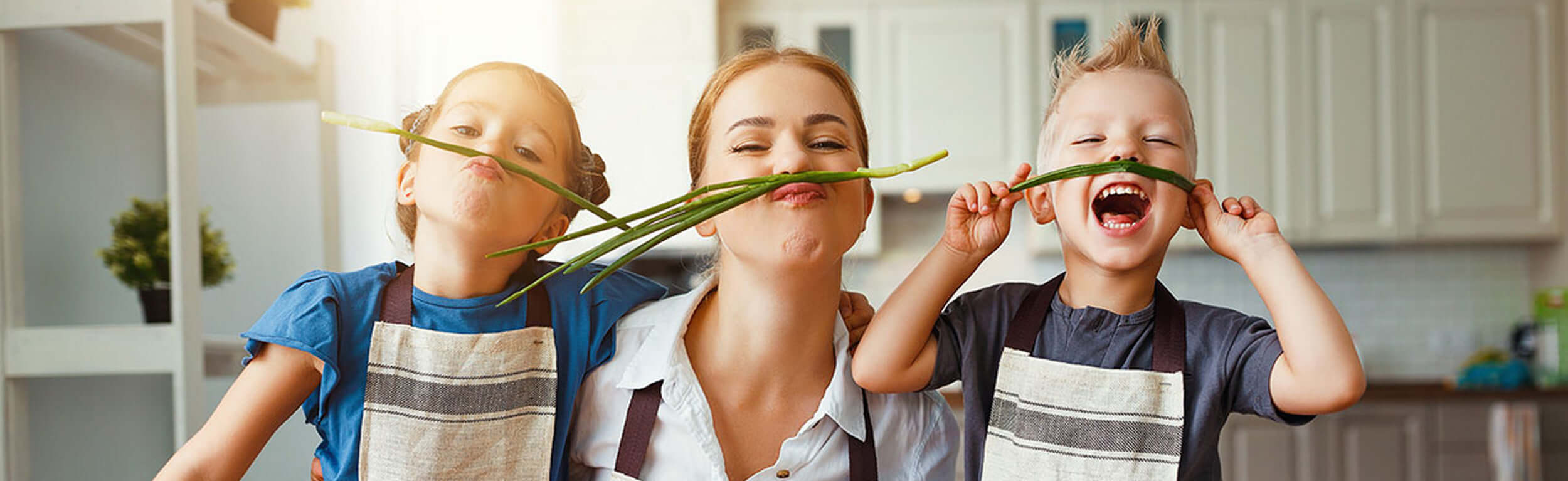 mom having fun in the kitchen with her children