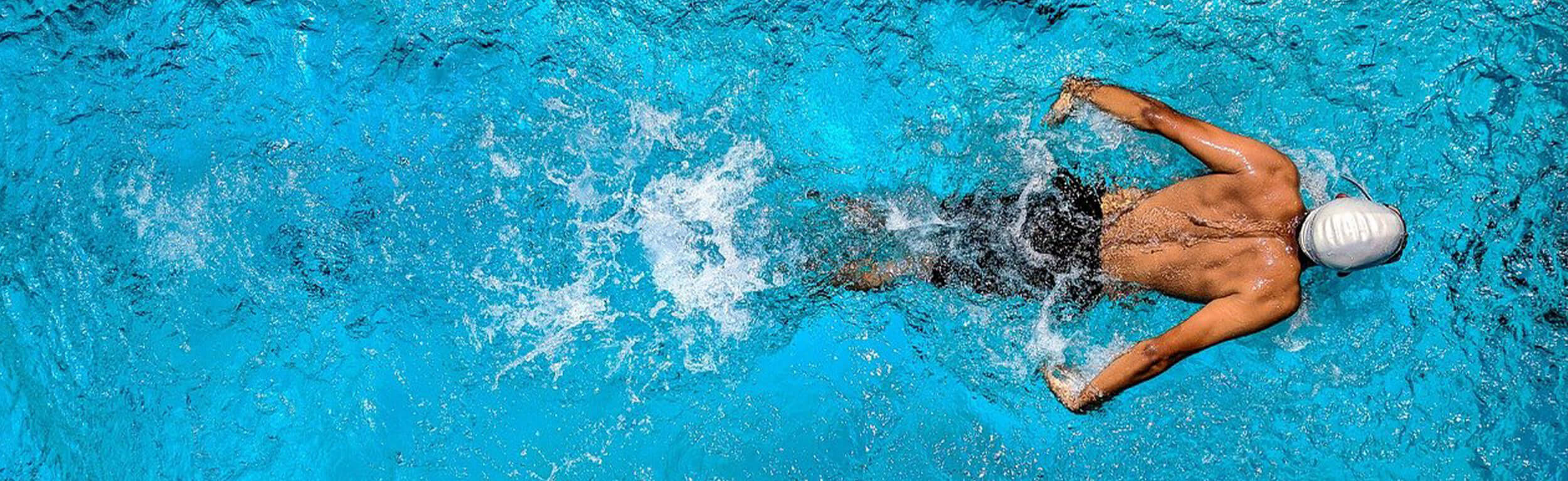 athletic swimmer doing the butterfly stroke