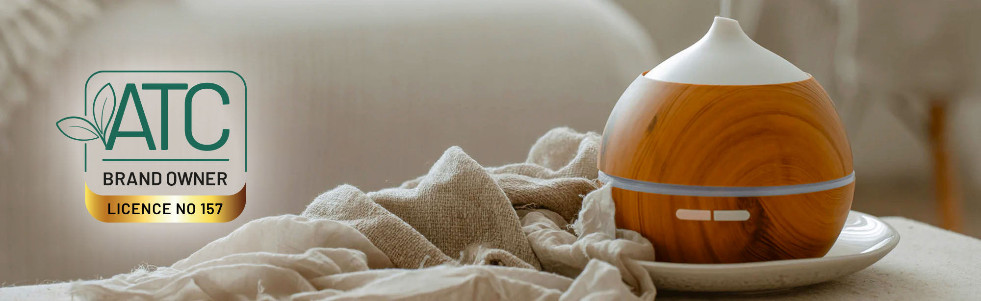 ATC Logo next to a wooden aromatherapy diffuser