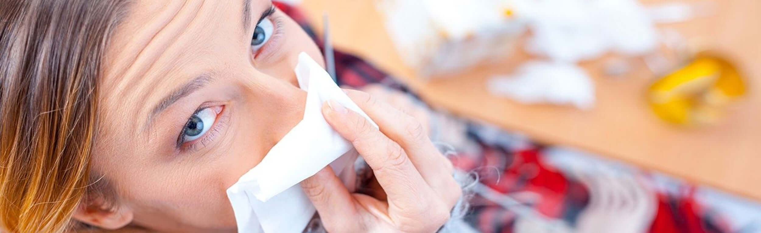 lady blowing her nose with a tissue