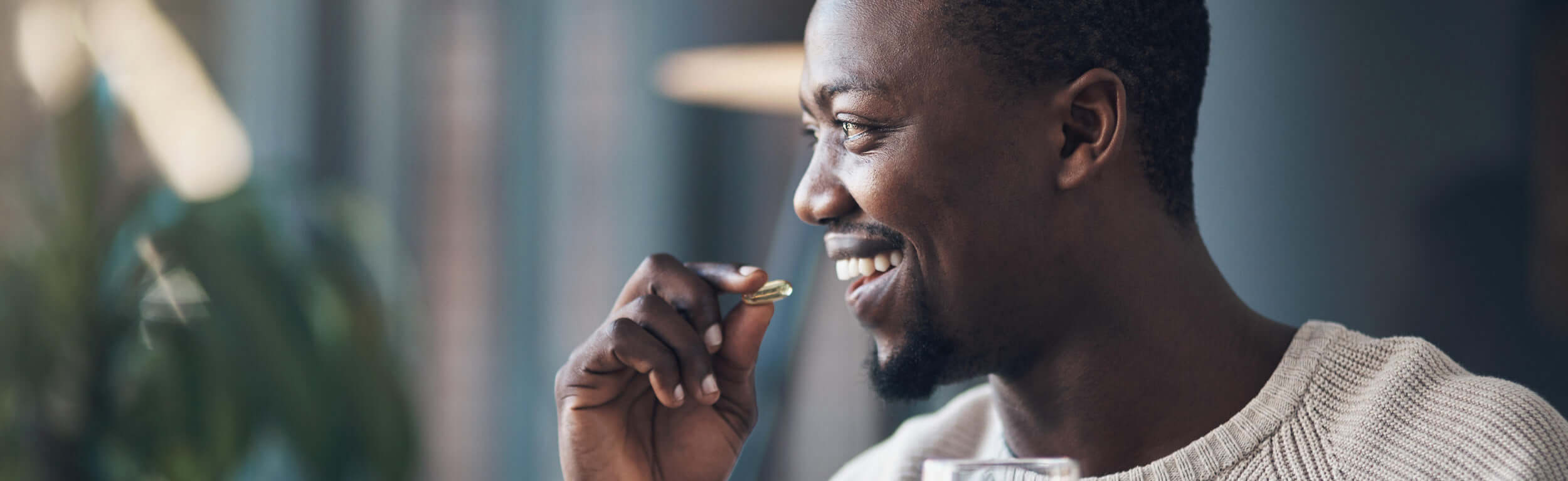 coloured male taking a cod liver capsule