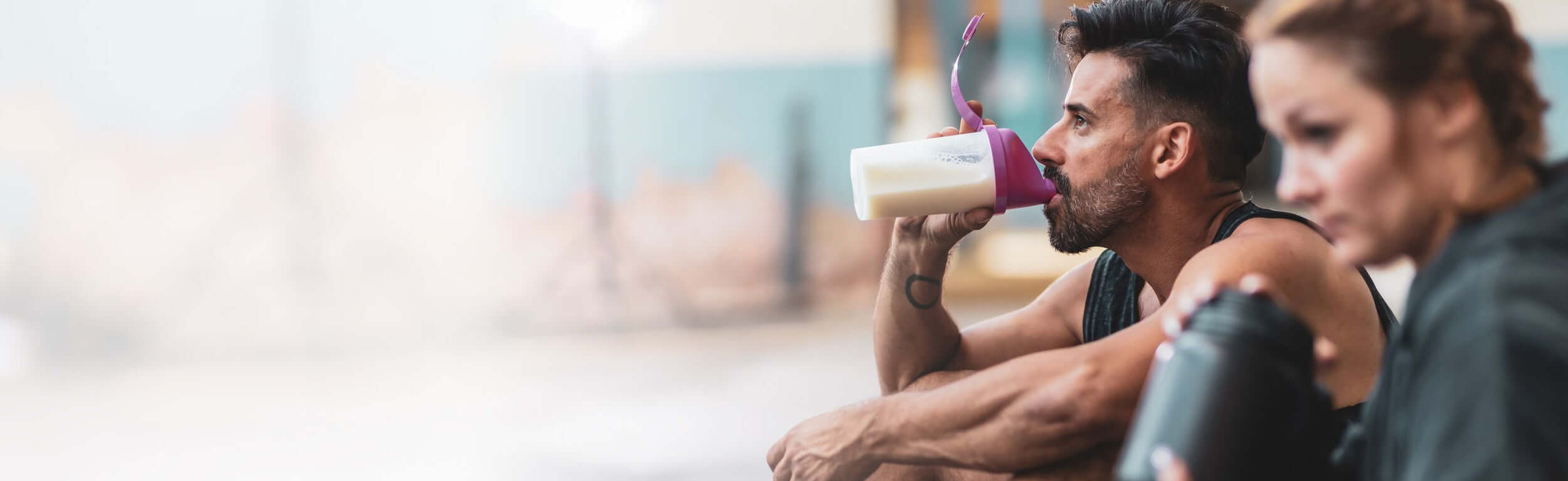 couple drinking protein after a workout