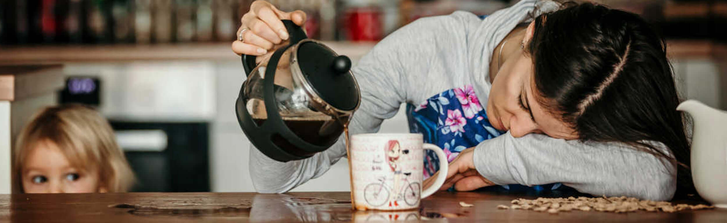 shatered mother pouring coffee over the table as she fell asleep