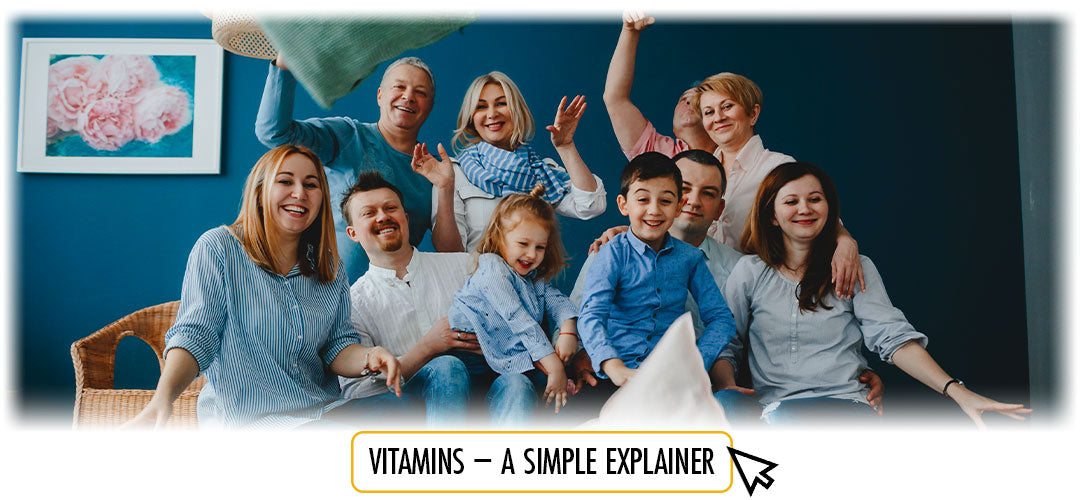 Happy multi-generational family together with 'Vitamins - A Simple Explainer' text, showcasing Lily & Loaf's commitment to family health.