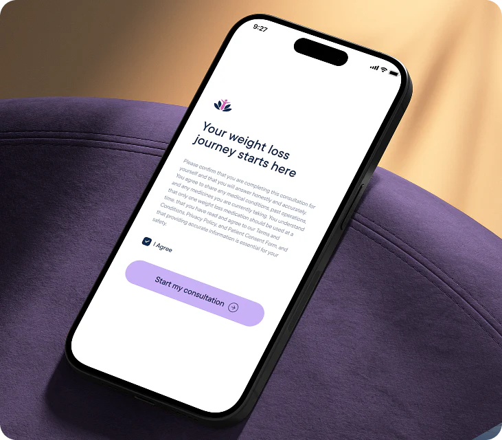 A smartphone lying on a purple cushion, displaying a weight loss consultation app screen with text and a purple 'Start my consultation' button.