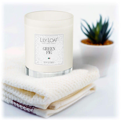 Green Fig Soy Wax Candle sat up on fresh folded towels