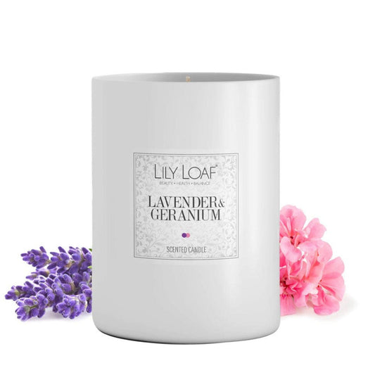 Lily & Loaf Lavender & Geranium Soy Wax Candle with lavender and geranium flowers around the base