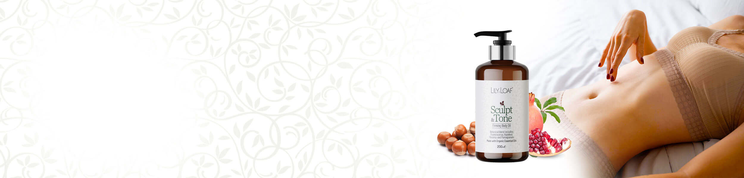 Bottle of Sculpt & Tone Firming Body Oil with a floral design on a textured white background