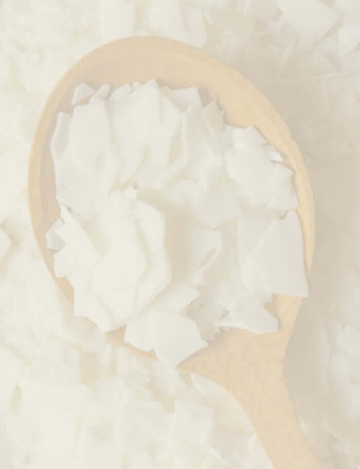 Soy wax shavings on a wooden spoon