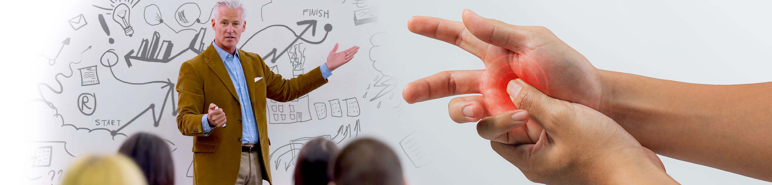 Person pointing to a hand with a red circle indicating pain, standing in front of a whiteboard with diagrams.