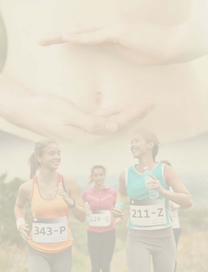 Three women running in a race with numbers on their vests.