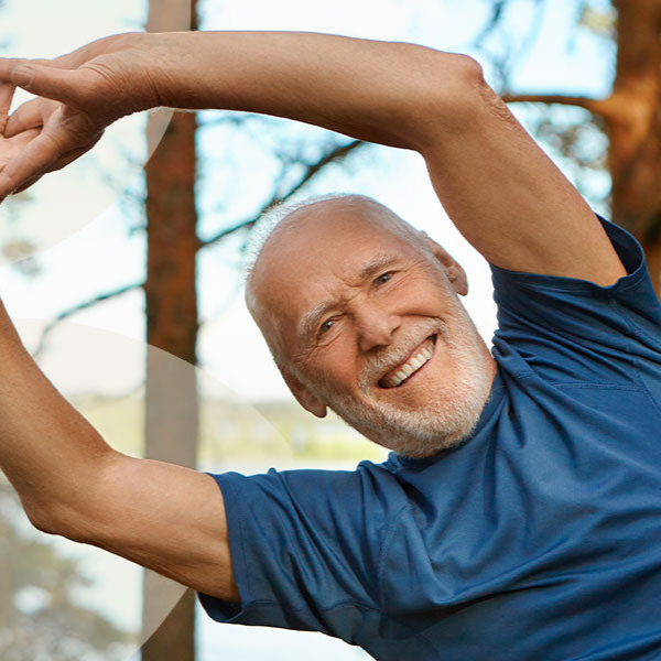 Man stretching outdoors with a blurred natural background