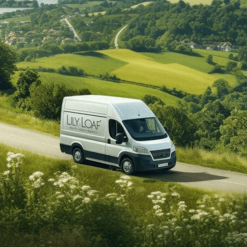 A white van with Lily & Loaf livery driving through a country lane