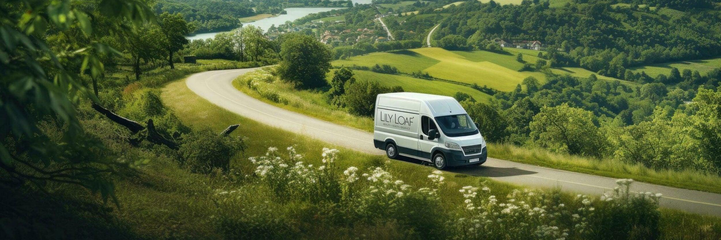A van with the Lily & Loaf logo driving through a winding country scene with hills and valleys