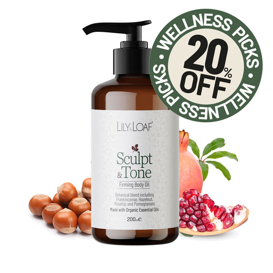 Sculpt & Tone Firming Body Oil surrounded by botanical ingredients including hazelnuts and pomegranate. A green circular promotional badge reading 'Wellness Picks 20% Off' is overlaid in the upper right.