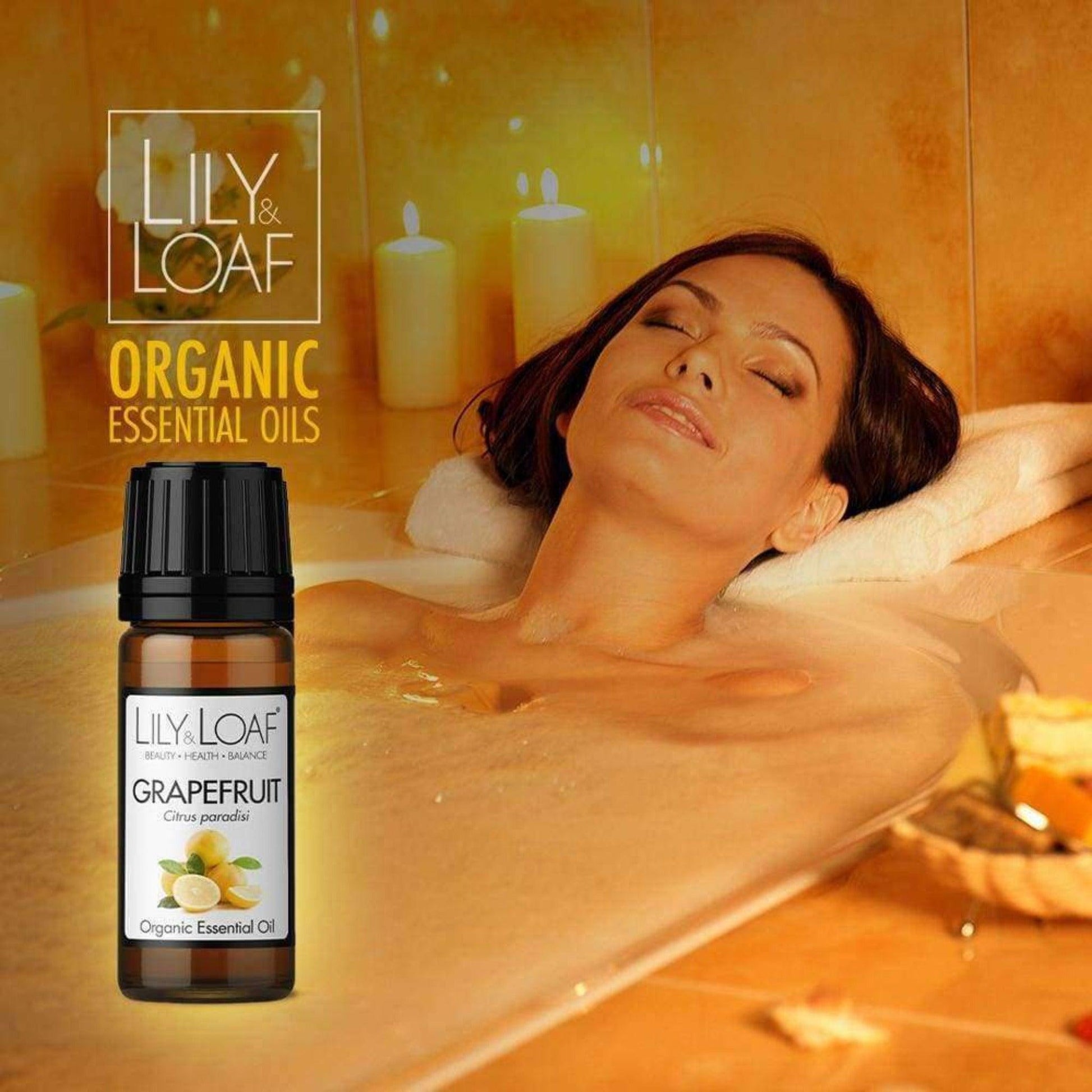 A woman enjoying a candle lit bath Grapefruit 10ml Organic Essential Oil 