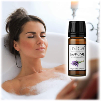 A woman relaxing in a bath with candles around Lavender Essential Oil