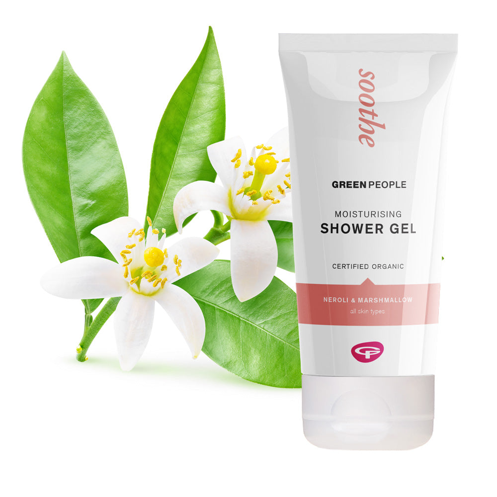 Green People Soothe moisturising shower gel with neroli and marshmallow, shown with fresh green leaves and white blossoms