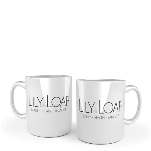 Two white ceramic mugs with the Lily & Loaf logo printed on the front and back.