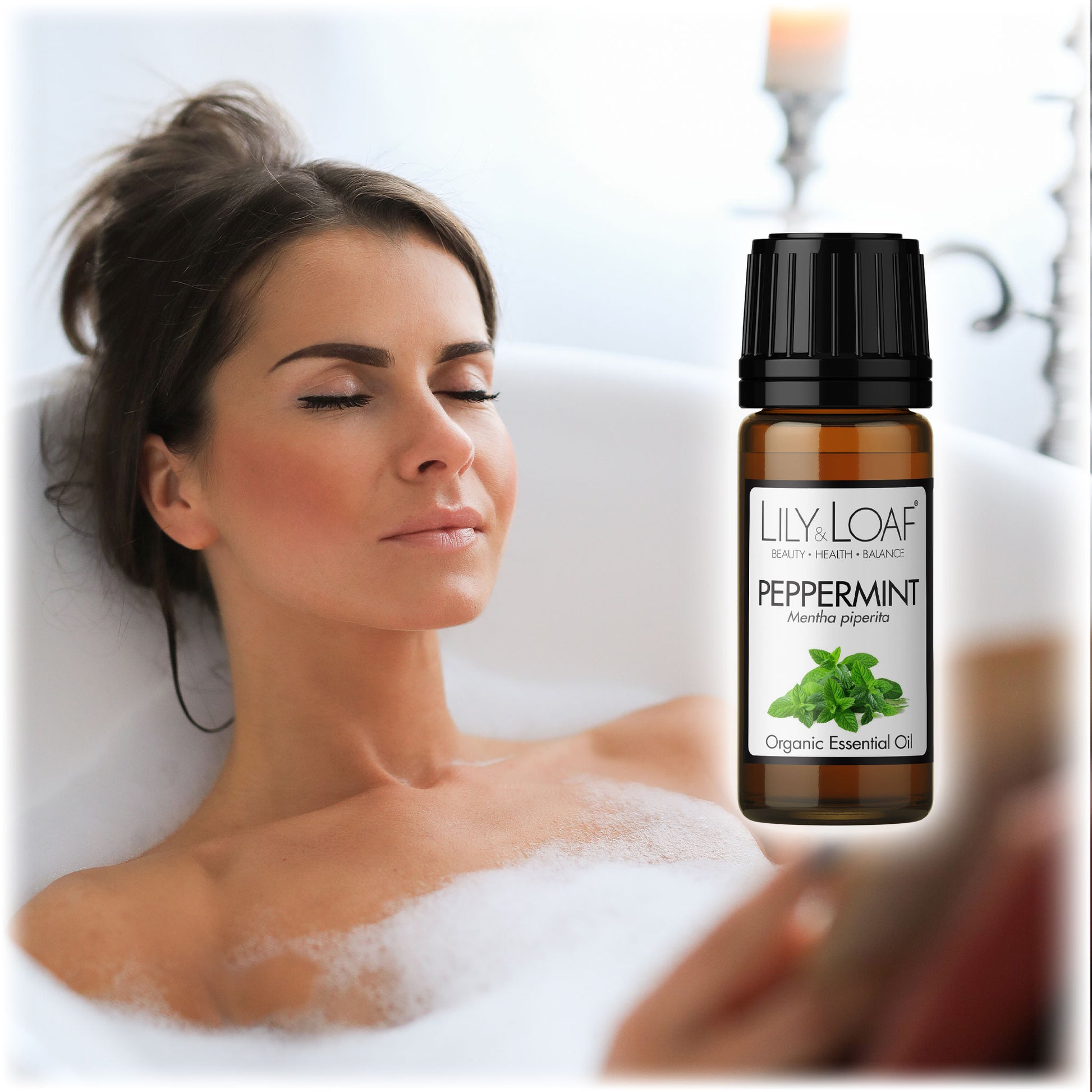 Woman relaxing in a bubble bath with a bottle of Lily & Loaf Peppermint essential oil in the foreground. Promotes relaxation and rejuvenation.