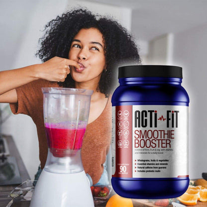 Person blending a bright pink smoothie in a kitchen alongside Acti-Fit Smoothie Booster powder tub for daily fibre, fruit and vitamin support.